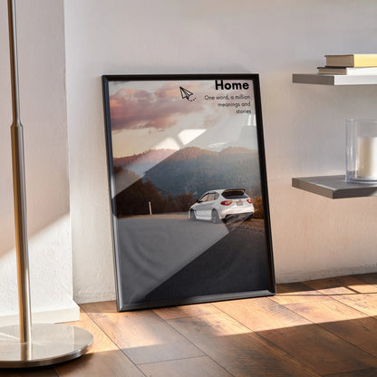 Subaru WRX STI driving on mountain road at sunset motivational poster wall art in black frame.