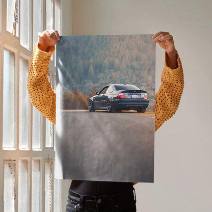 BMW E46 M3 poster with sleek rear view on scenic road, high-resolution automotive wall art.