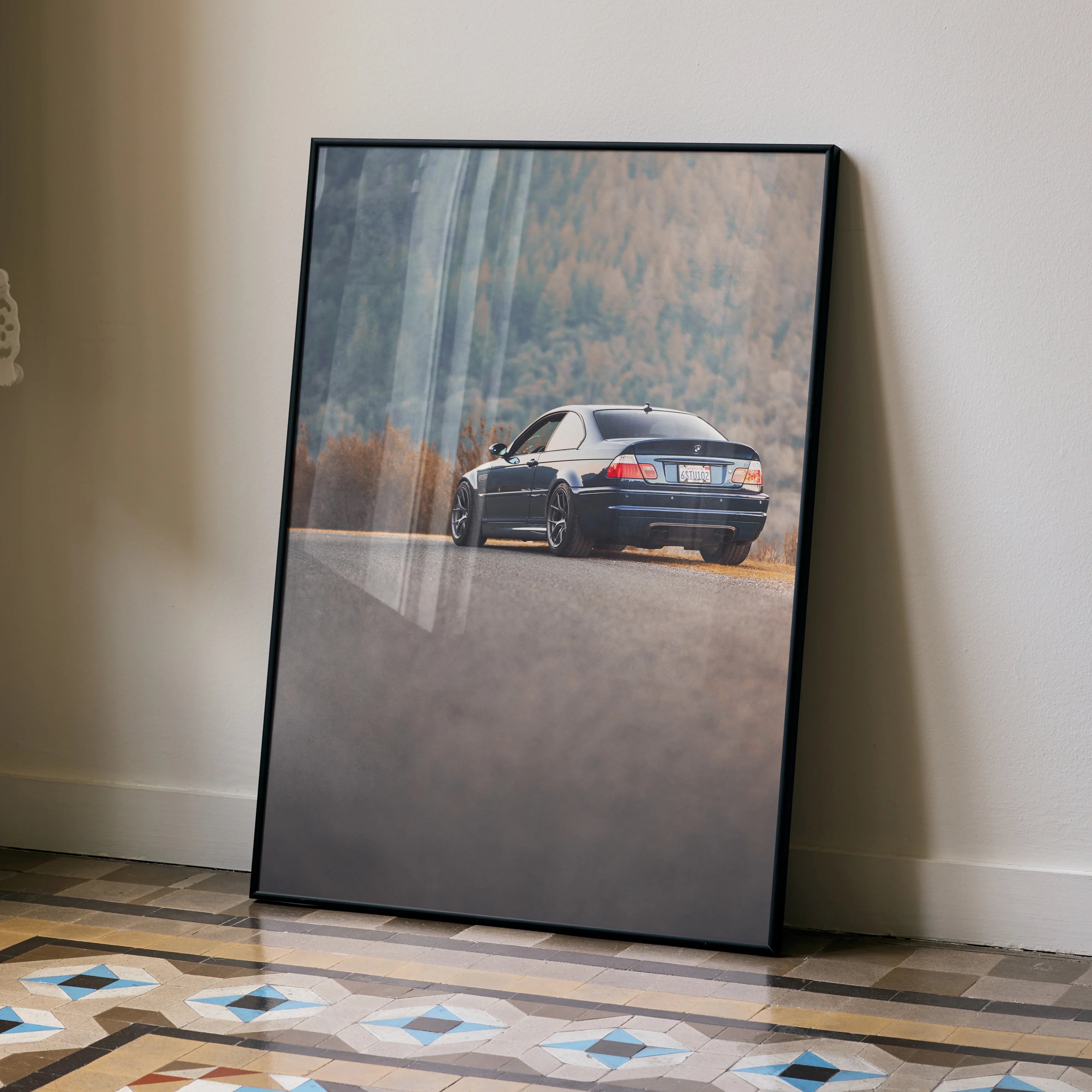 BMW E46 M3 poster showing rear view of car on road with forest background wall art.