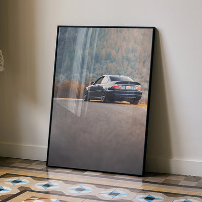 BMW E46 M3 poster showing rear view of car on road with forest background wall art.