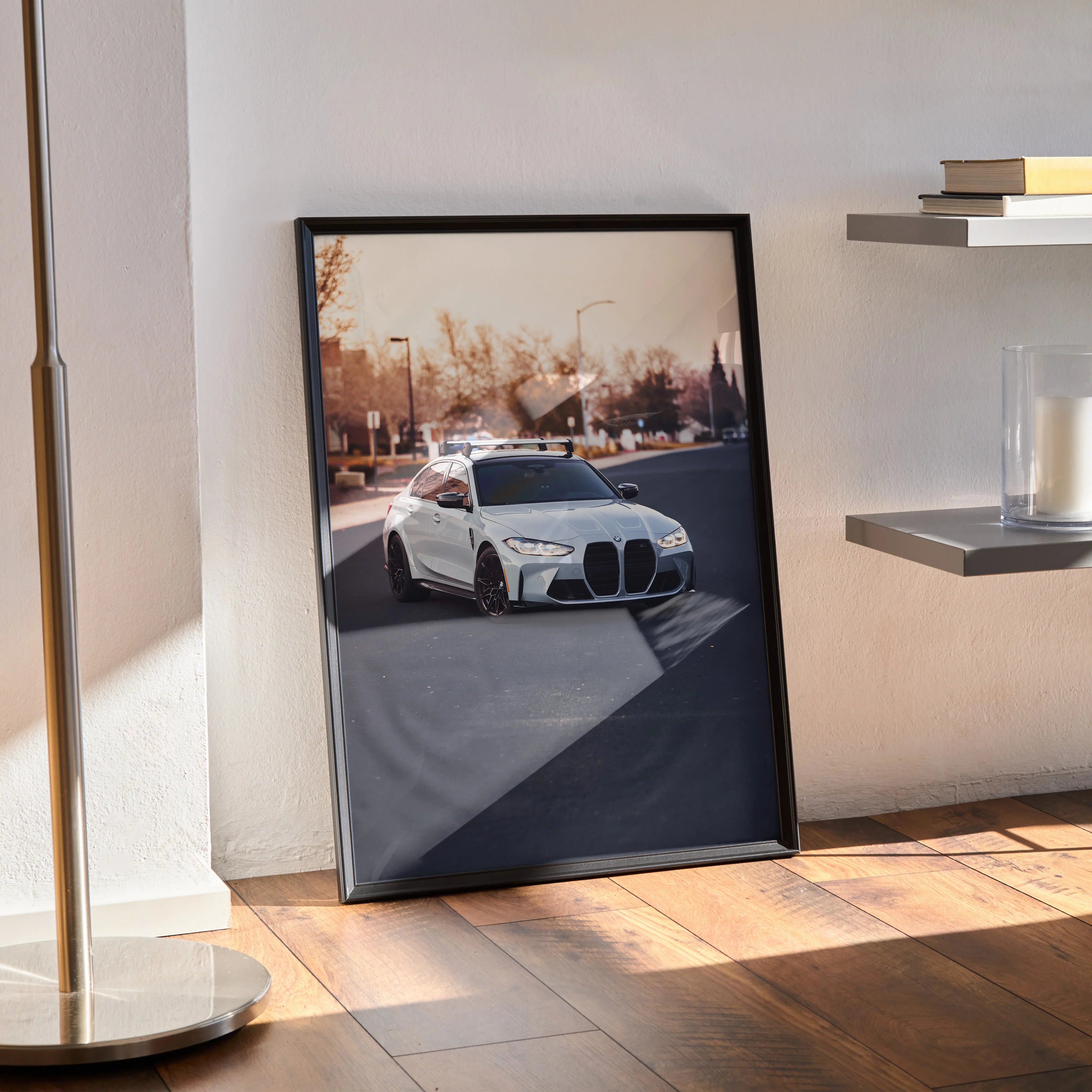 BMW G80 M3 poster featuring a white car on city street, sleek black frame wall art.