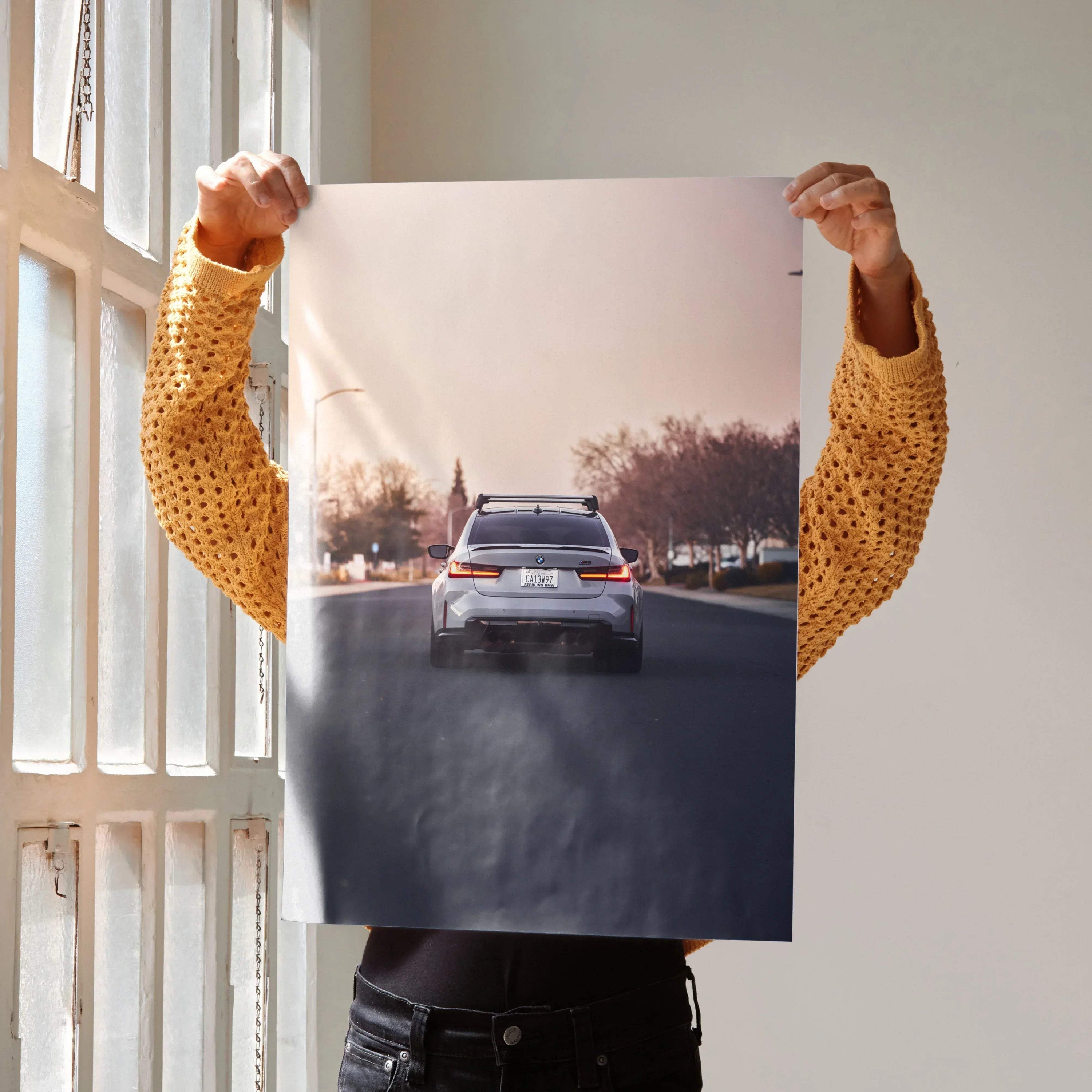 BMW G80 M3 rear view driving on road poster wall art with sunset background.