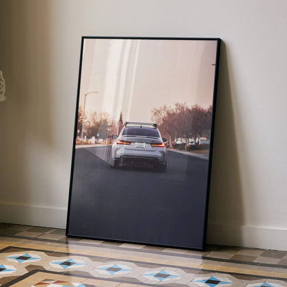 BMW G80 M3 driving on sunlit road poster with modern cityscape wall art.