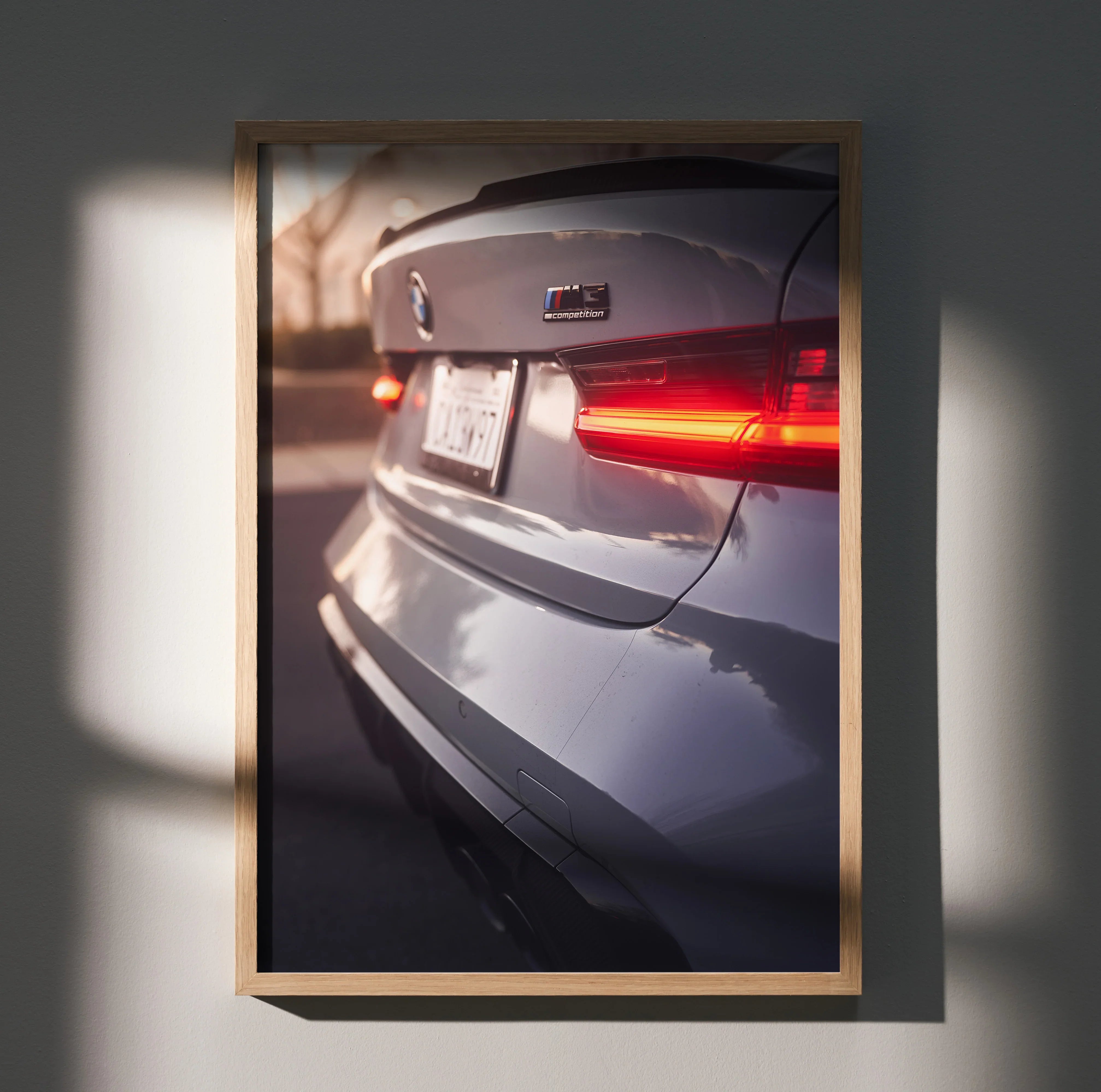 BMW G80 M3 rear close-up wall art poster with illuminated tail light and license plate.