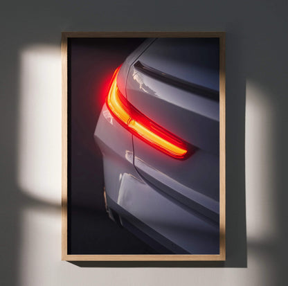 BMW G80 M3 rear close-up poster showcasing illuminated taillight in sleek gray, wall art with high contrast lighting.