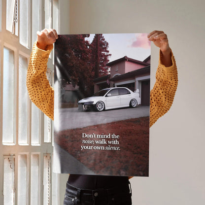 Motivational poster featuring white Mitsubishi Evo 8 parked in front of house with inspiring text wall art.