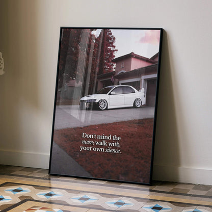 Motivational wall art poster featuring white Mitsubishi Evo 8 parked by a house with text "Don’t mind the noise, walk with.