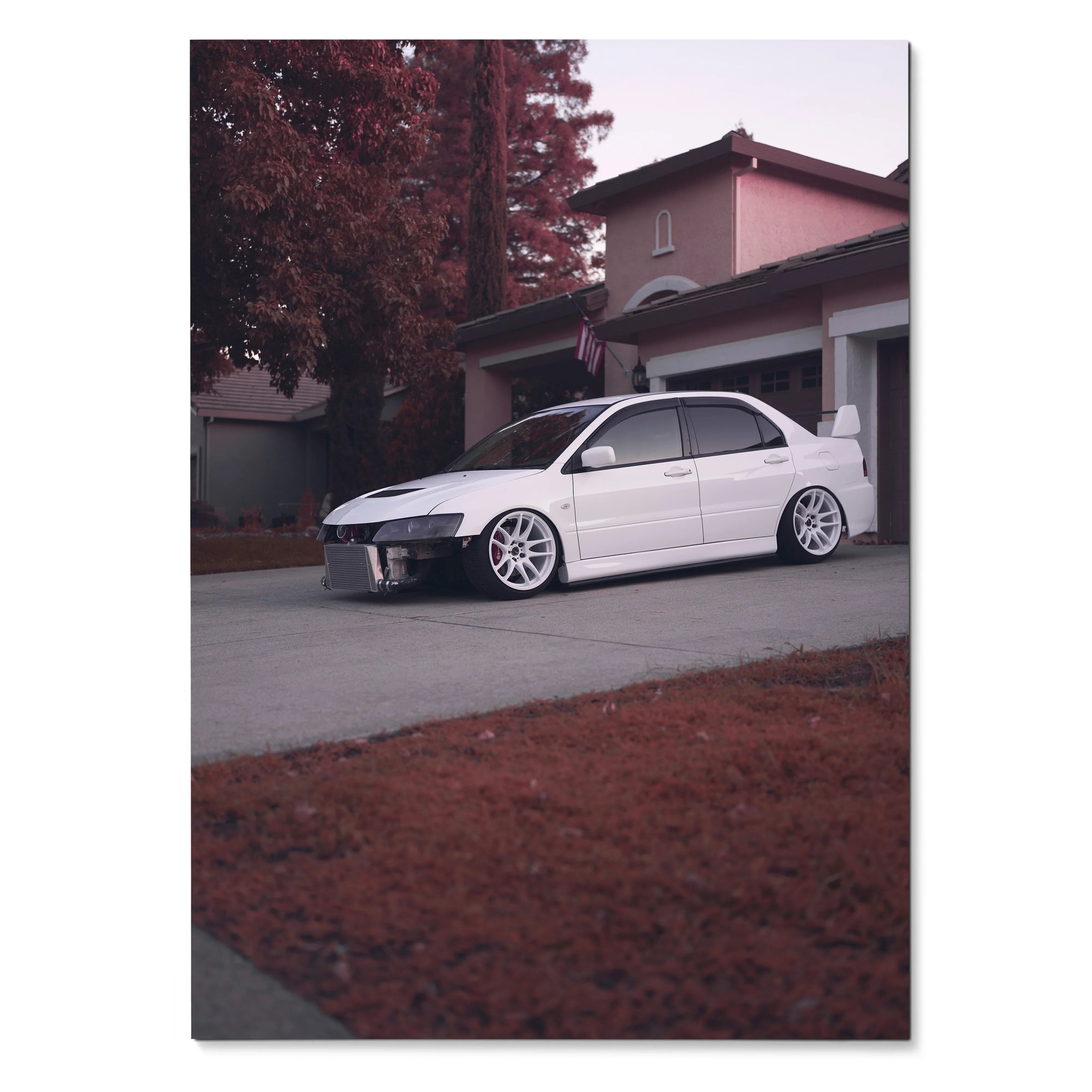 White Mitsubishi Evo 8 parked in driveway with house and autumn trees background poster wall art.
