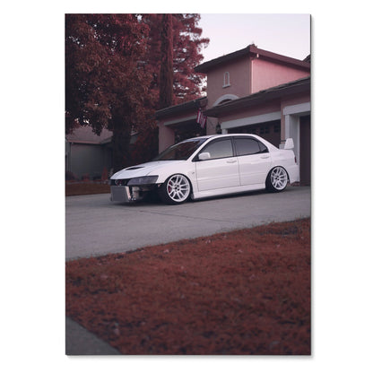 White Mitsubishi Evo 8 parked in driveway with house and autumn trees background poster wall art.