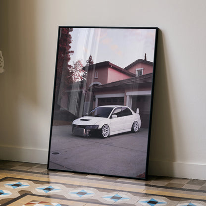 Mitsubishi Evo 8 art poster with white car parked in front of house, modern wall art in black frame.