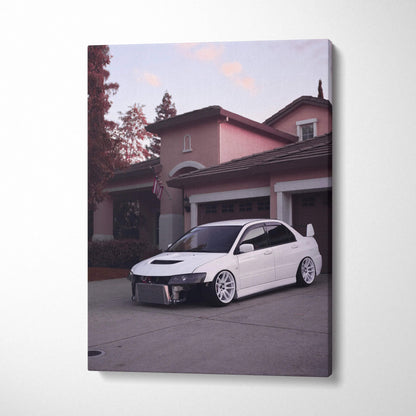 Vertical canvas art wall decor featuring a white Mitsubishi Evo 8 parked in front of a residential garage at dusk.