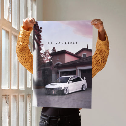 Motivational poster wall art featuring white Mitsubishi Evo 8 parked in front of a house at sunset with "Be Yourself" text.