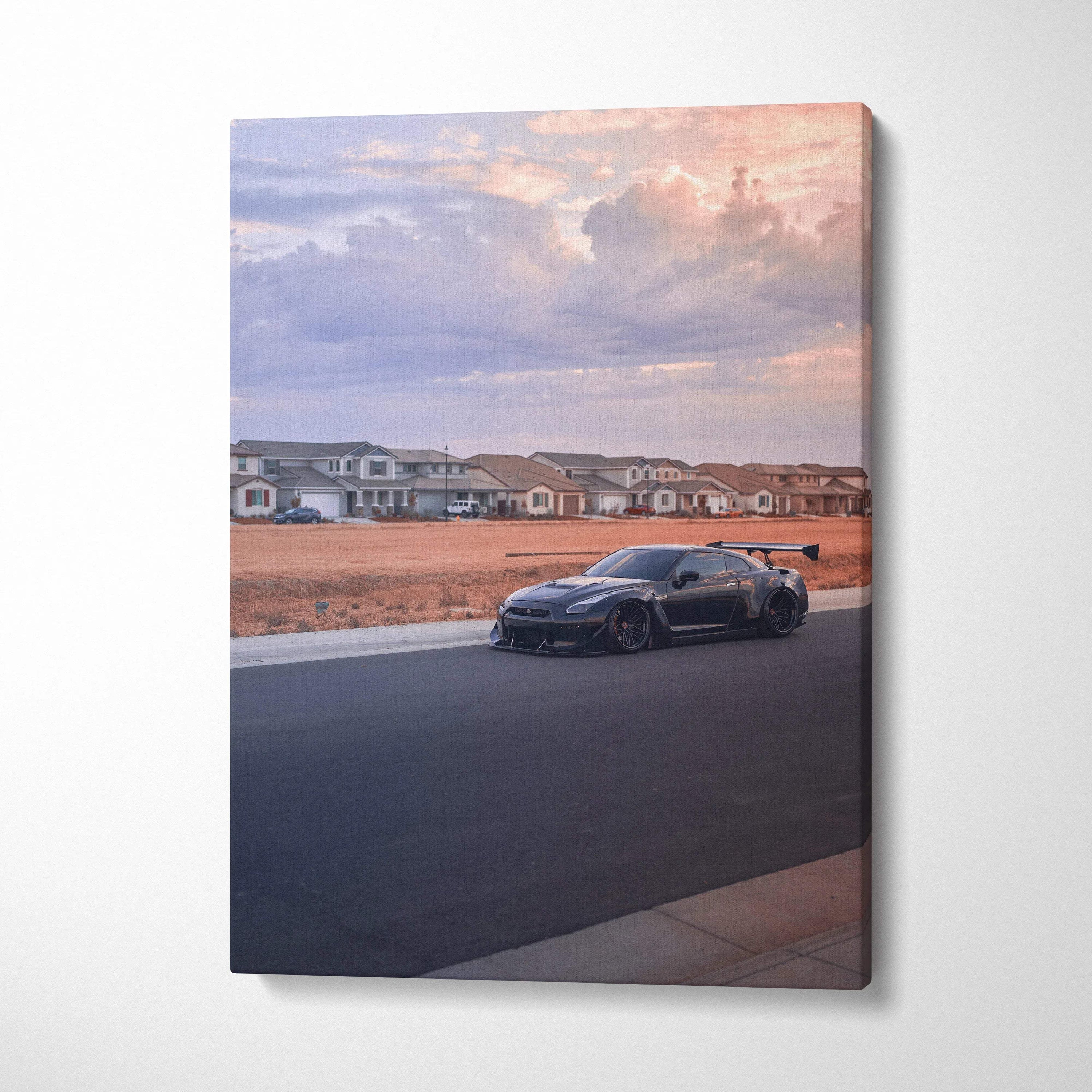 Nissan R35 GTR parked on quiet street at sunset with soft sky on vertical canvas wall art.