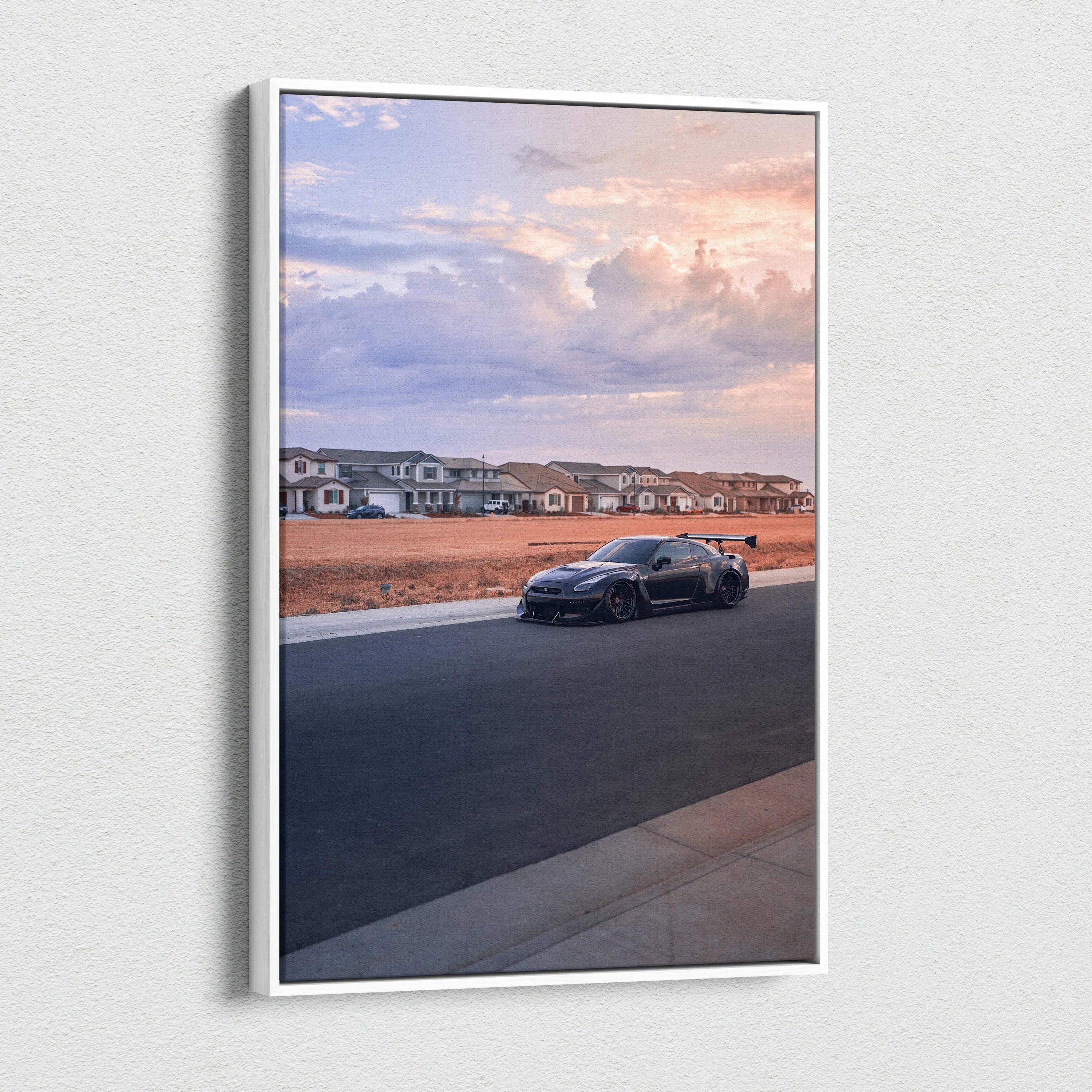 Vertical canvas wall art featuring a black Nissan R35 GTR on a suburban street at sunset.