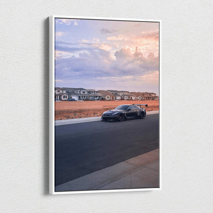 Vertical canvas wall art featuring a black Nissan R35 GTR on a suburban street at sunset.