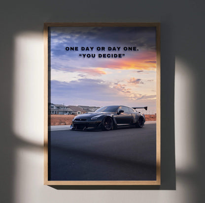 Motivational poster wall art featuring a black Nissan R35 GT-R with inspiring text "One day or day one. You decide" at sunset.