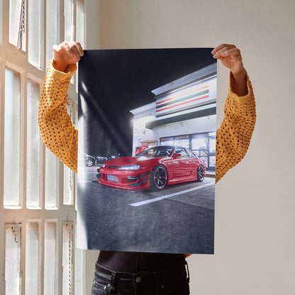 Poster wall art featuring a red Nissan 240sx S14 Kouki parked under bright modern building lights at night.