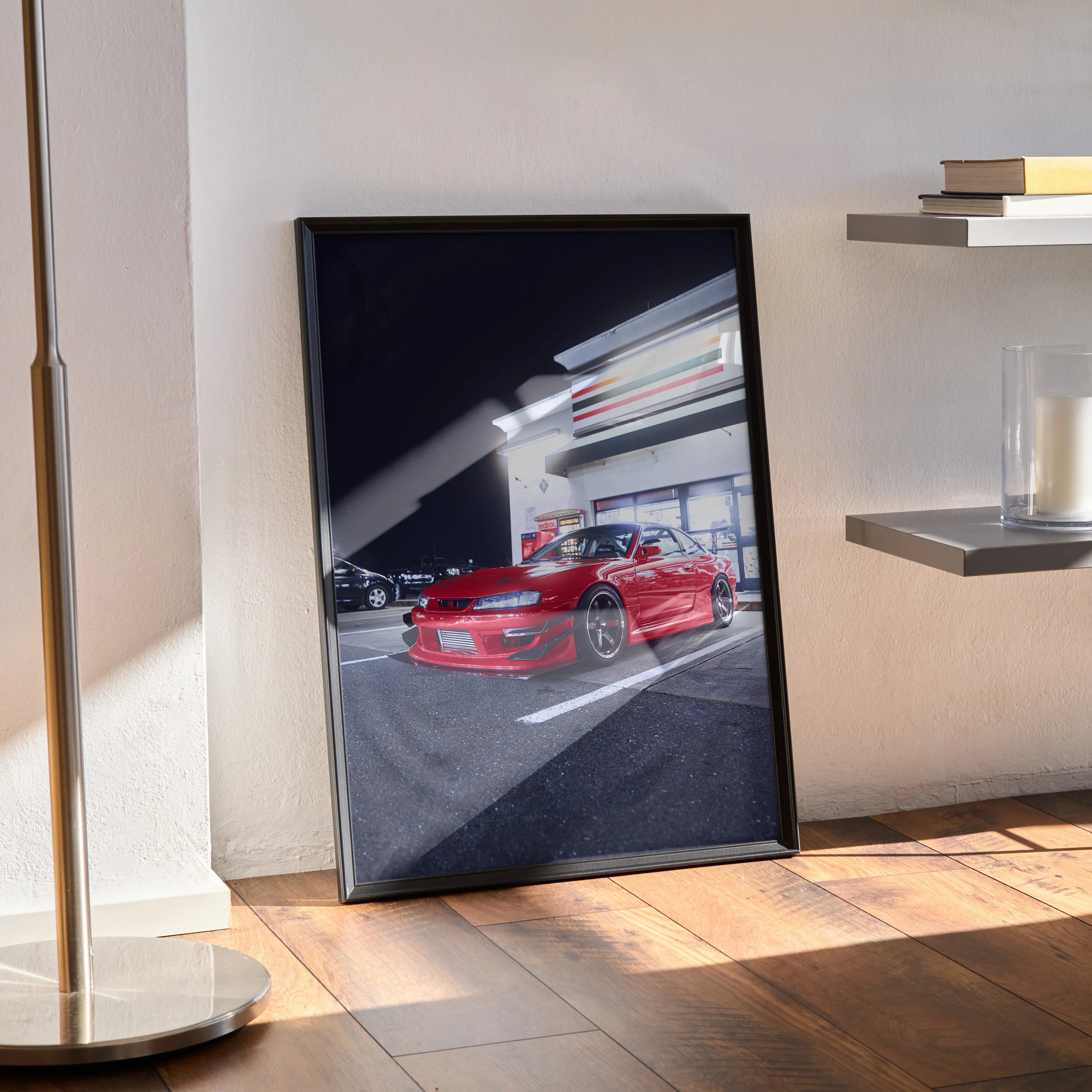 Framed Nissan 240sx S14 Kouki red sports car poster leaning on floor with modern interior wall art.