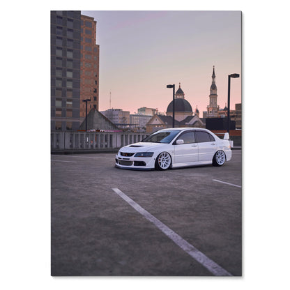 Mitsubishi Evo 8 parked on rooftop at sunset poster wall art with city skyline background.