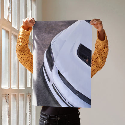 White Mitsubishi Evo 8 close-up poster held by person in mustard shirt, automotive wall art.
