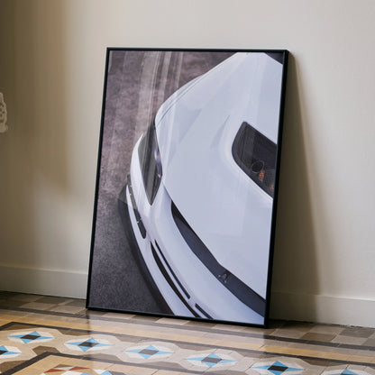 White Mitsubishi Evo 8 close-up poster with black frame leaning against beige wall, automotive wall art.