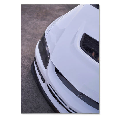 White Mitsubishi Evo 8 front close-up poster showcasing hood scoop and sleek headlights wall art.