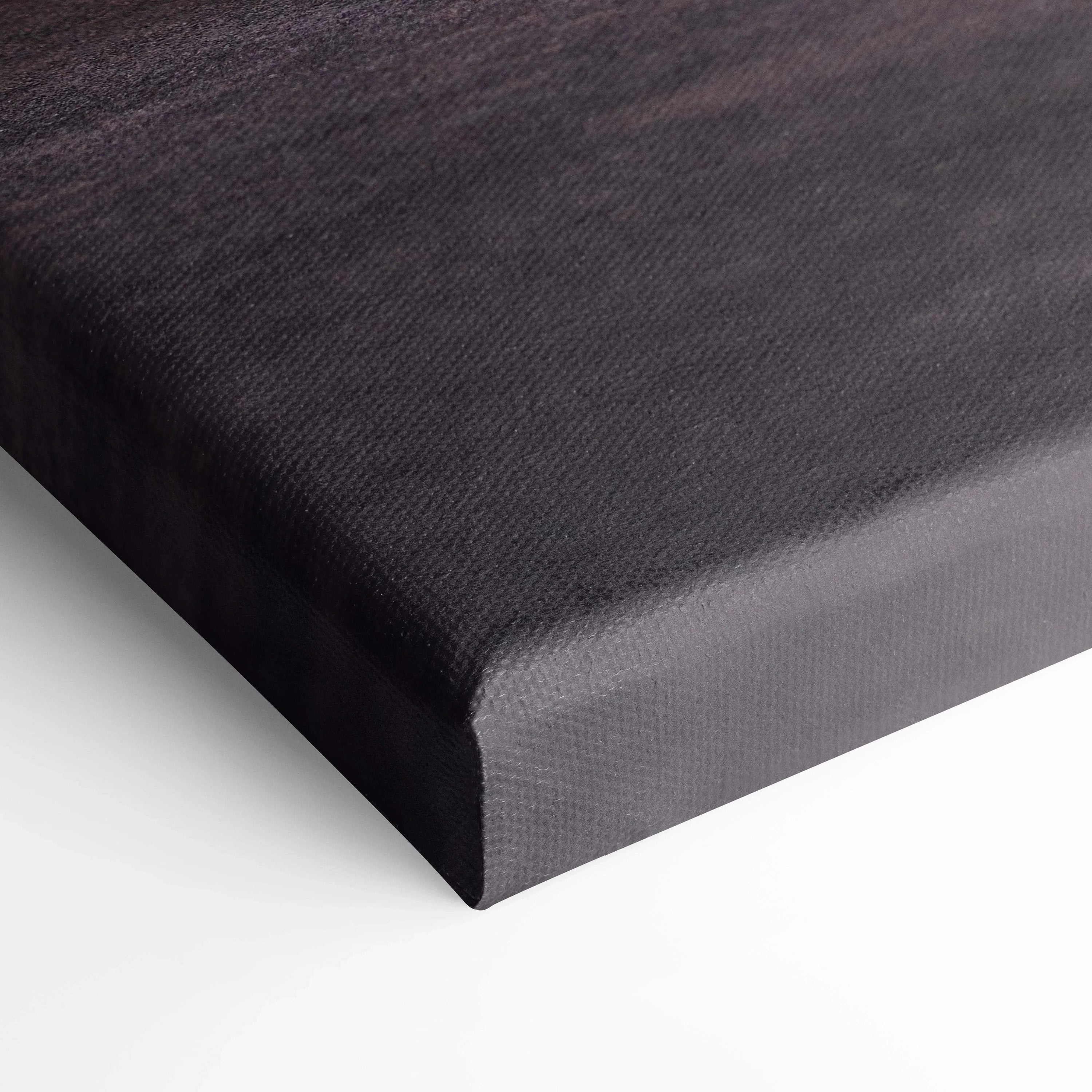 Close-up of black textured canvas art stretched over thick edges for wall art display.