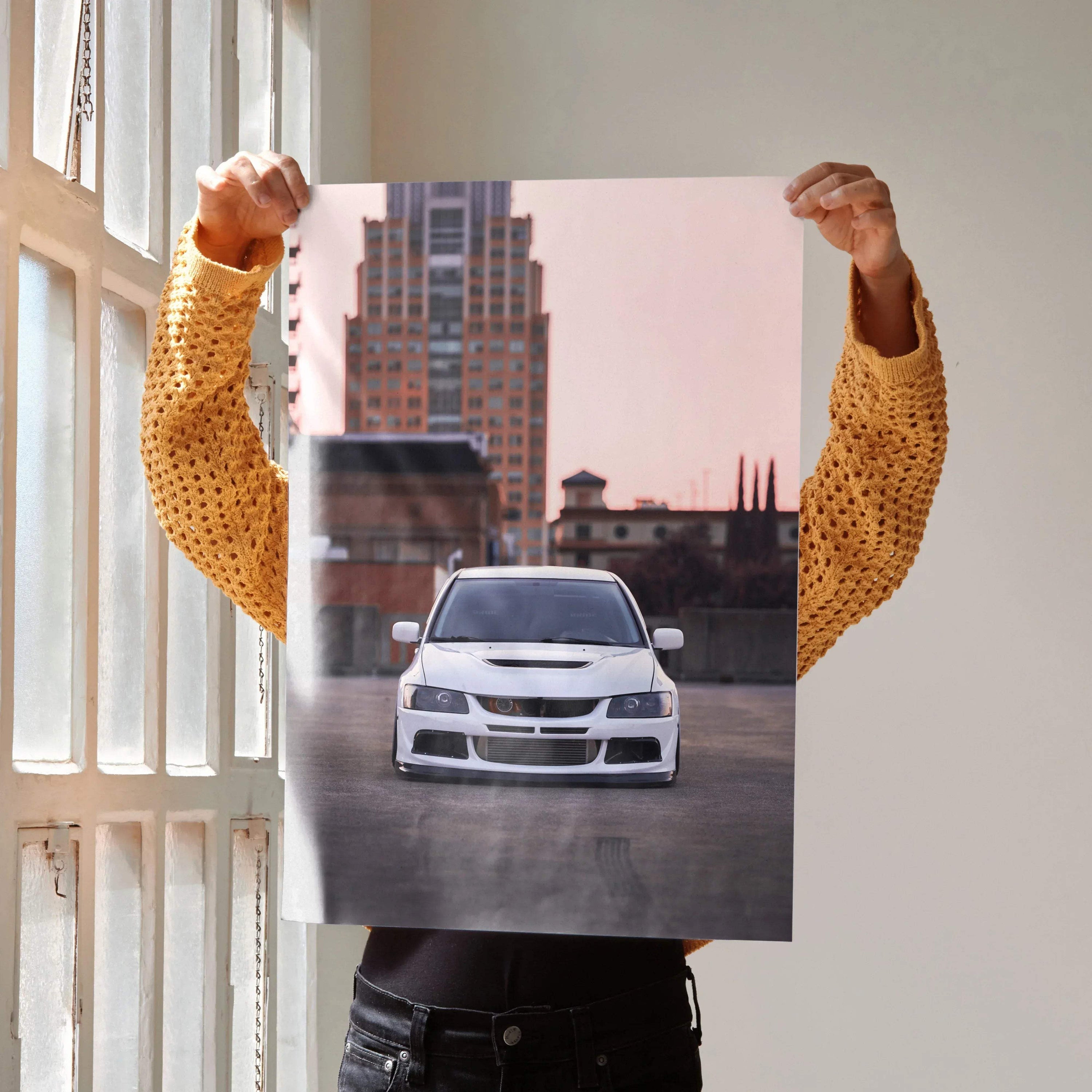 Mitsubishi Evo 8 front view against cityscape poster wall art with pink sky background.