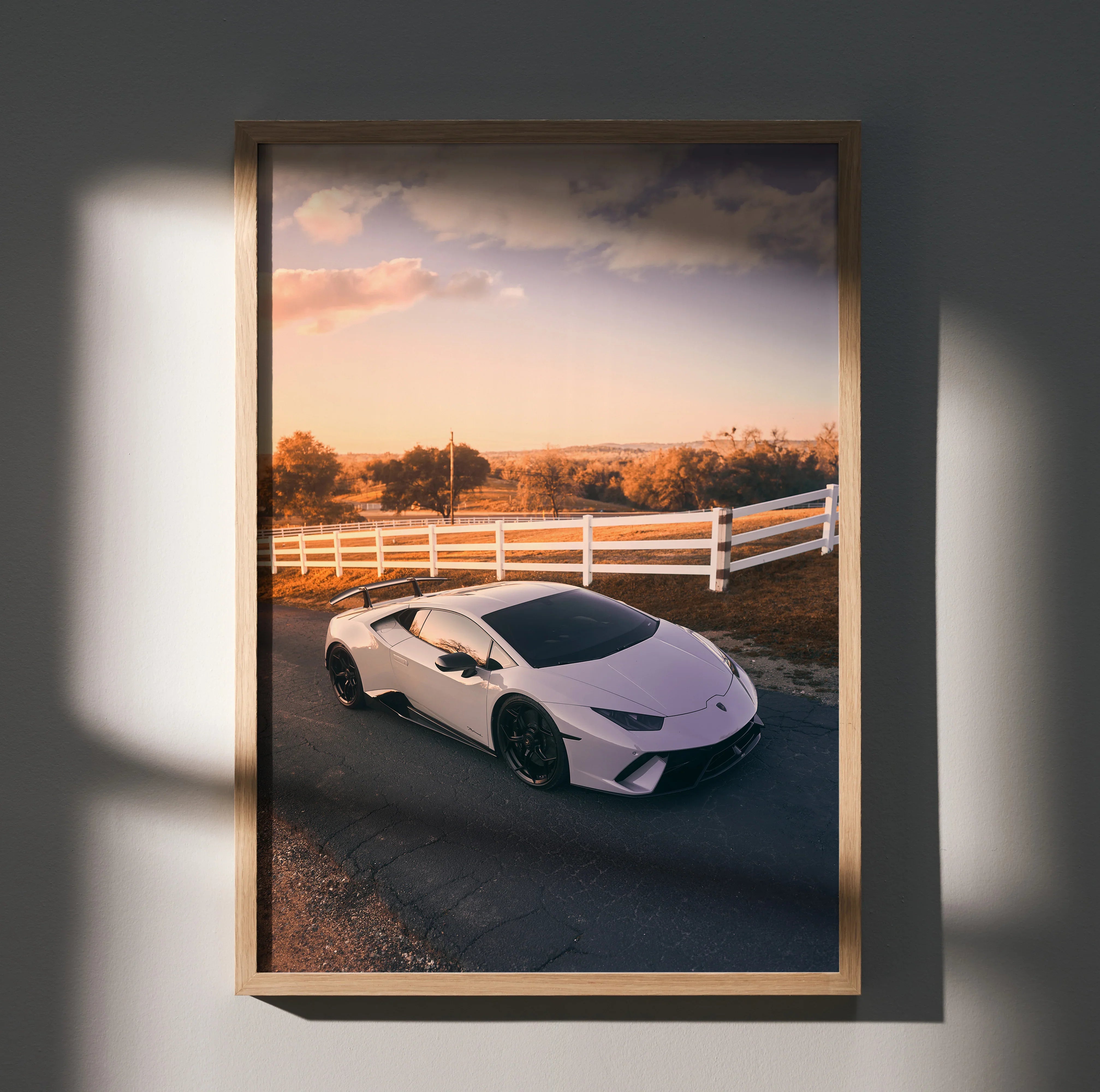 Lamborghini Huracan white sports car poster with sunset and white fence wall art.