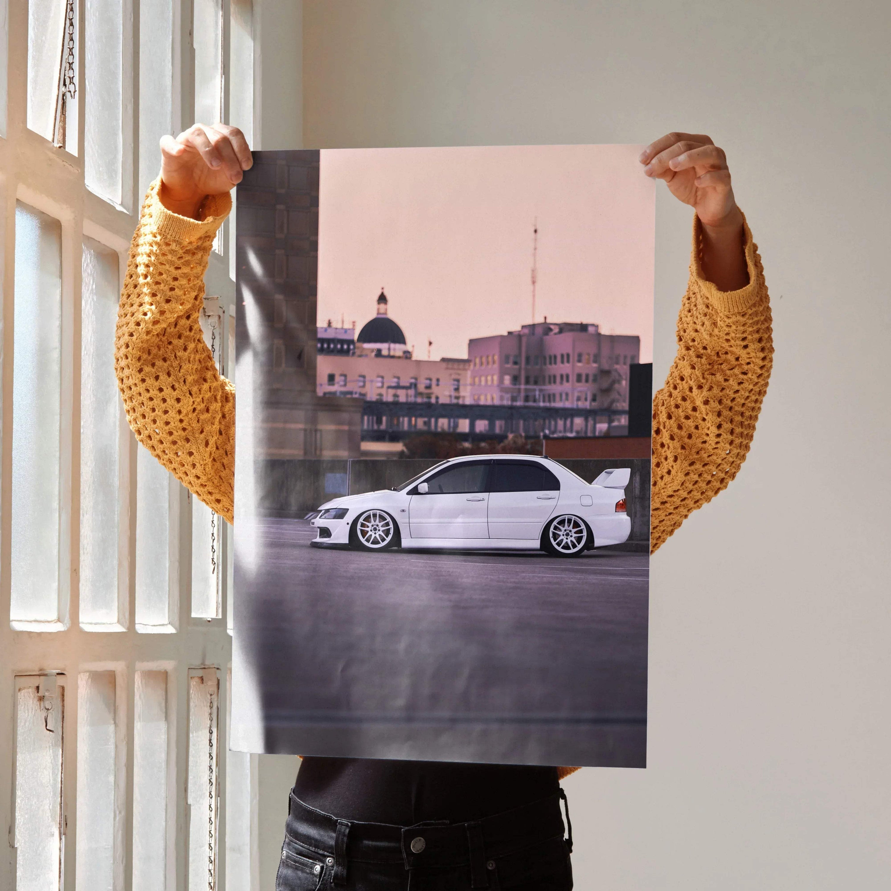 Mitsubishi Evo 8 white car poster with city skyline wall art in soft pink sky background.