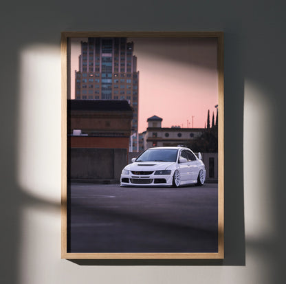 Mitsubishi Evo 8 white sports car poster with urban sunset background wall art in wooden frame.