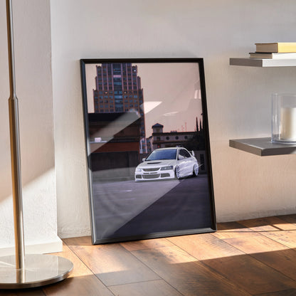 Framed Mitsubishi Evo 8 poster wall art with cityscape background, leaning against wall on wooden floor.