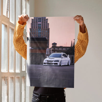 Mitsubishi Evo 8 in white on city street poster wall art with sunset sky background.