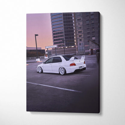White Mitsubishi Evo 8 parked in urban lot at sunset vertical canvas wall art.