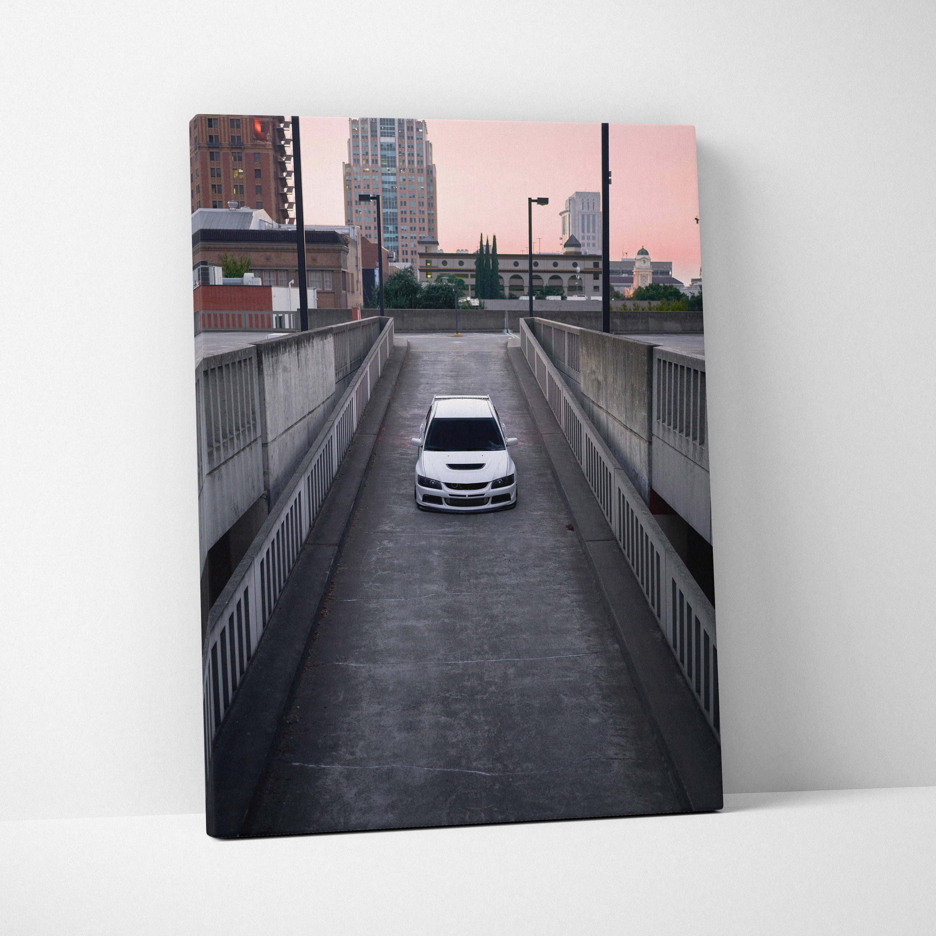 Vertical canvas art featuring a white Mitsubishi Evo 8 on urban road under pink sky wall art.