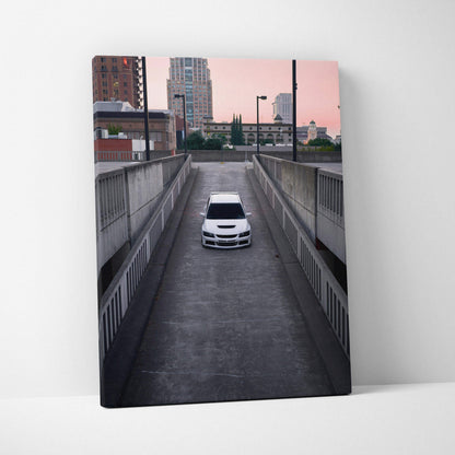 Vertical canvas art featuring a white Mitsubishi Evo 8 on urban road under pink sky wall art.