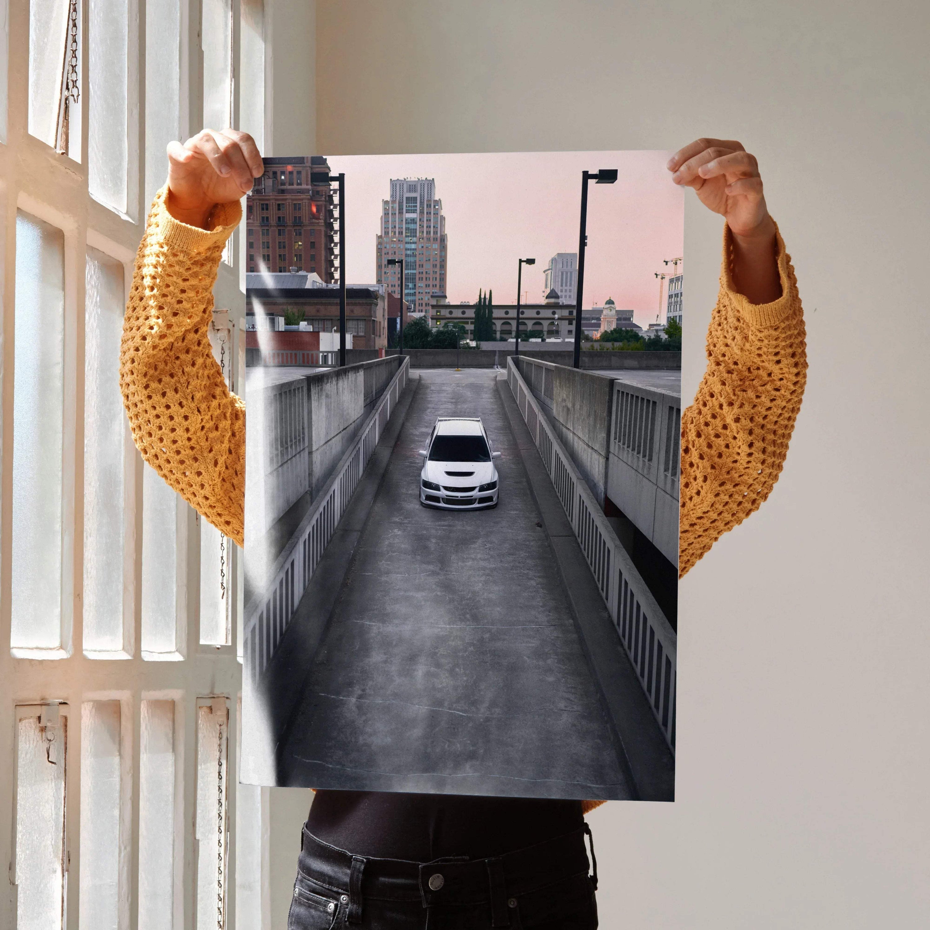 Mitsubishi Evo 8 driving down urban driveway poster wall art with cityscape background.