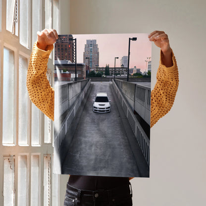 Mitsubishi Evo 8 driving down urban driveway poster wall art with cityscape background.