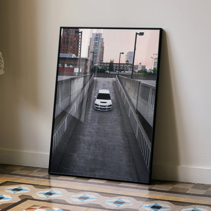 Mitsubishi Evo 8 poster wall art showing white car parked in urban concrete ramp with cityscape background.