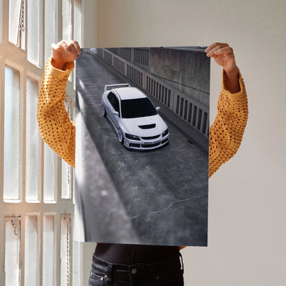 Mitsubishi Evo 8 white sports car poster wall art angled overhead view in urban setting.