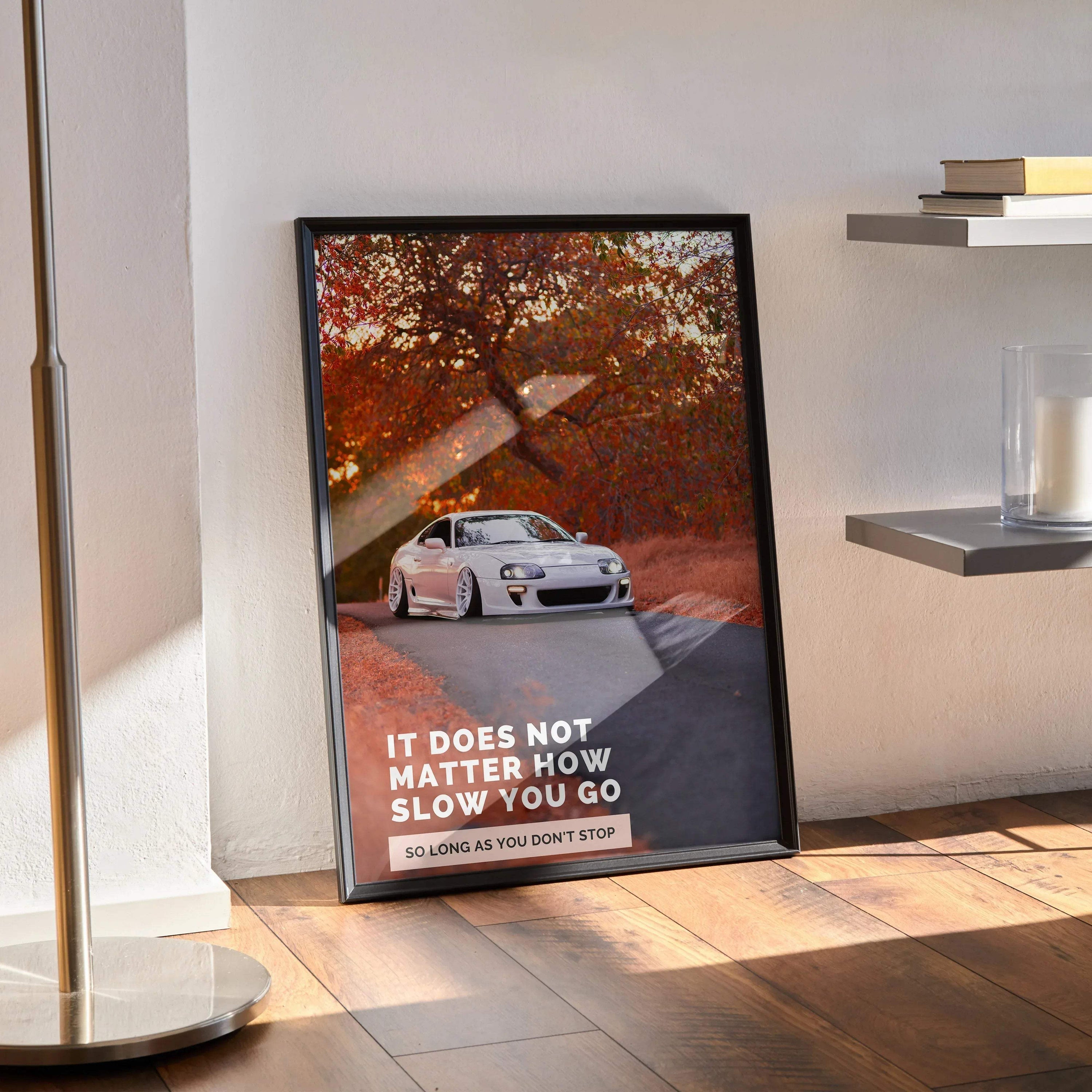 Toyota Supra Mk4 poster with inspirational text and autumn trees wall art in black frame.