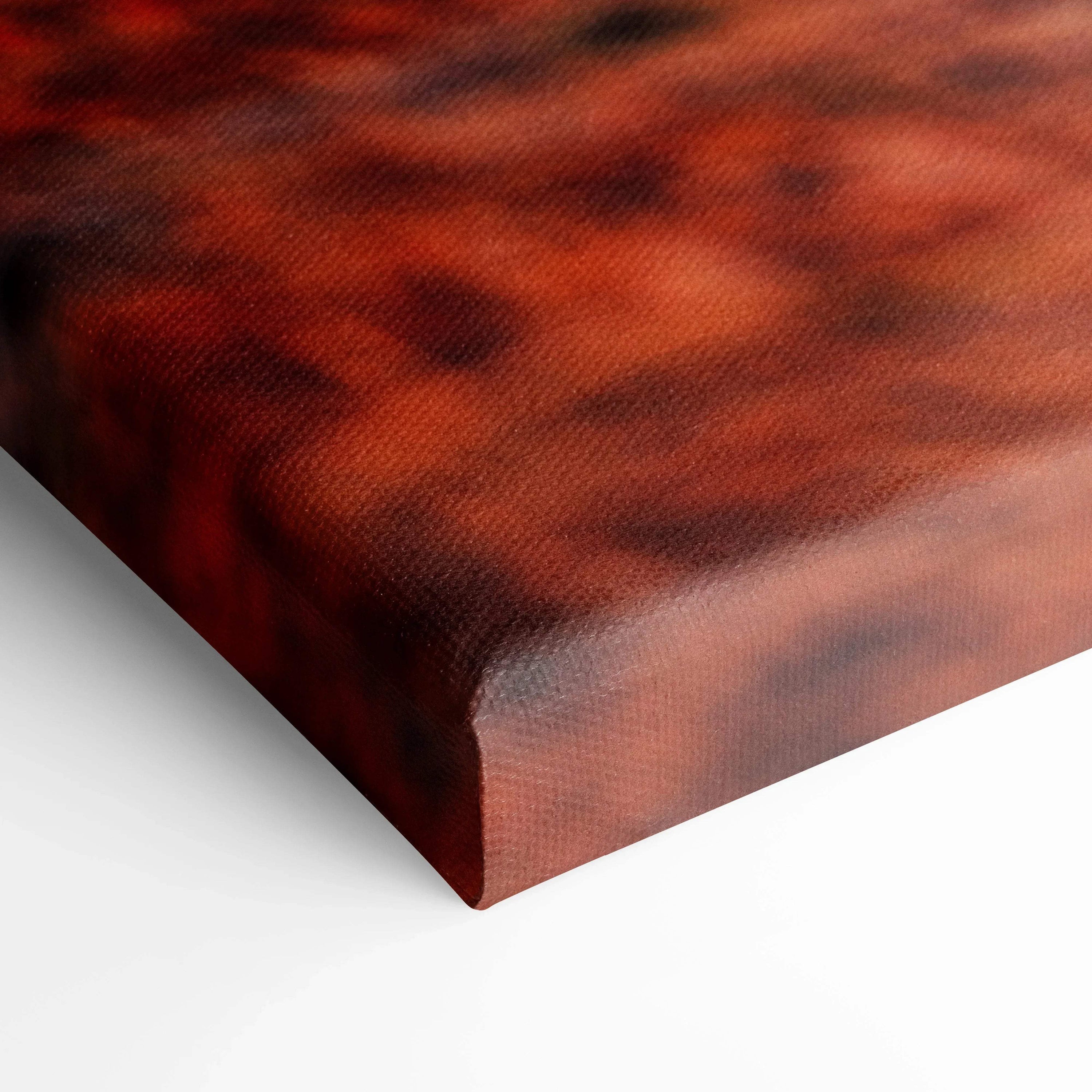 Close-up of textured canvas wall art with deep red and black abstract fiery design.