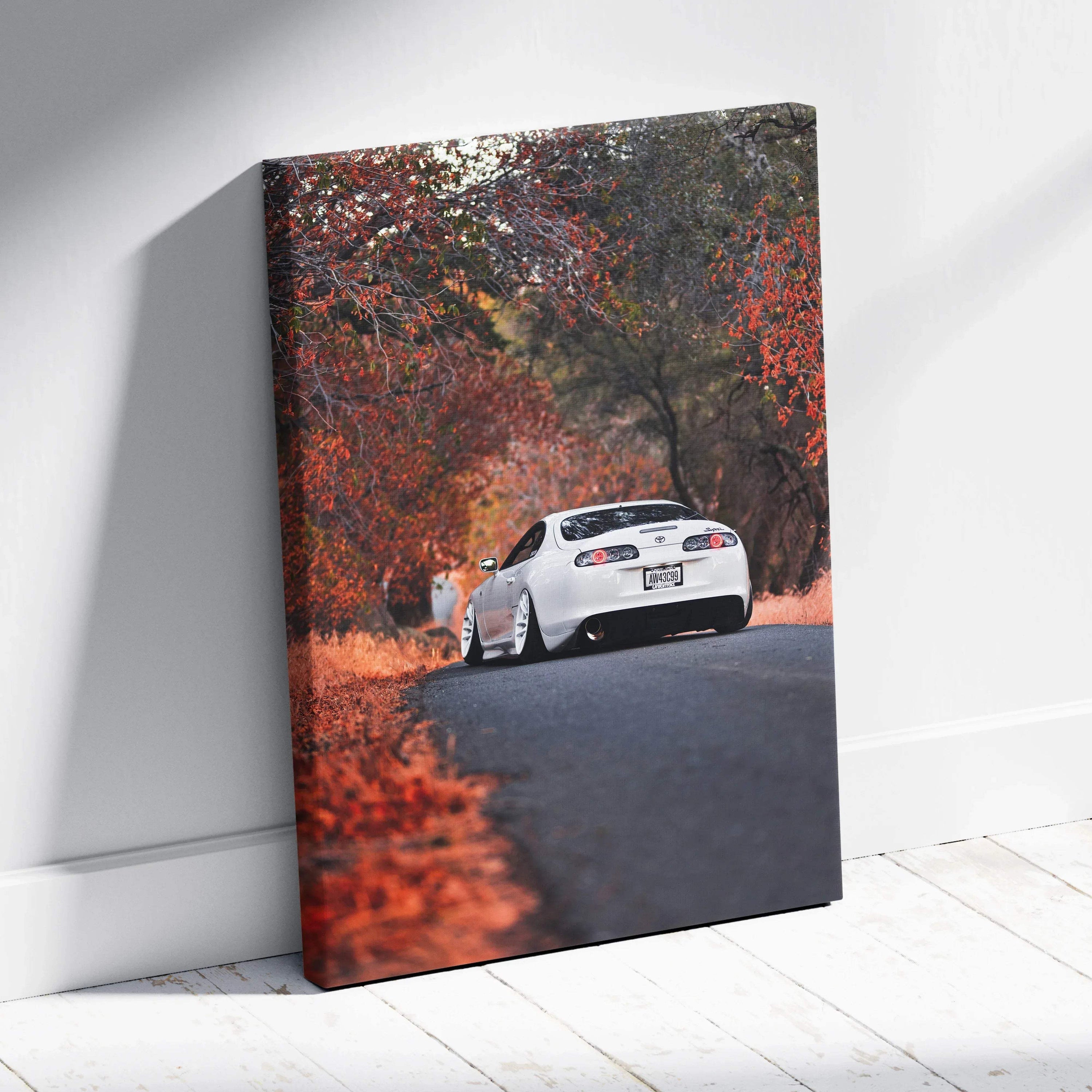 Toyota Supra MK4 driving on autumn road canvas wall art with vibrant fall colors vertical canvas art.