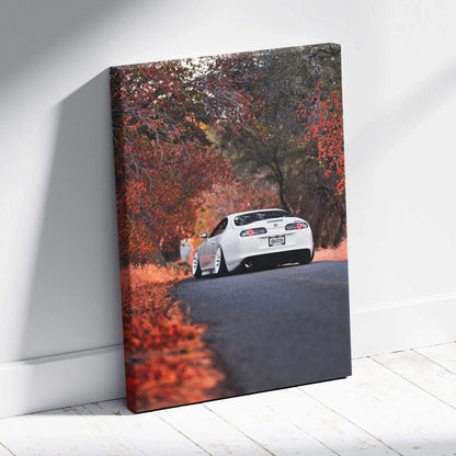 Toyota Supra MK4 driving on autumn road canvas wall art with vibrant fall colors vertical canvas art.