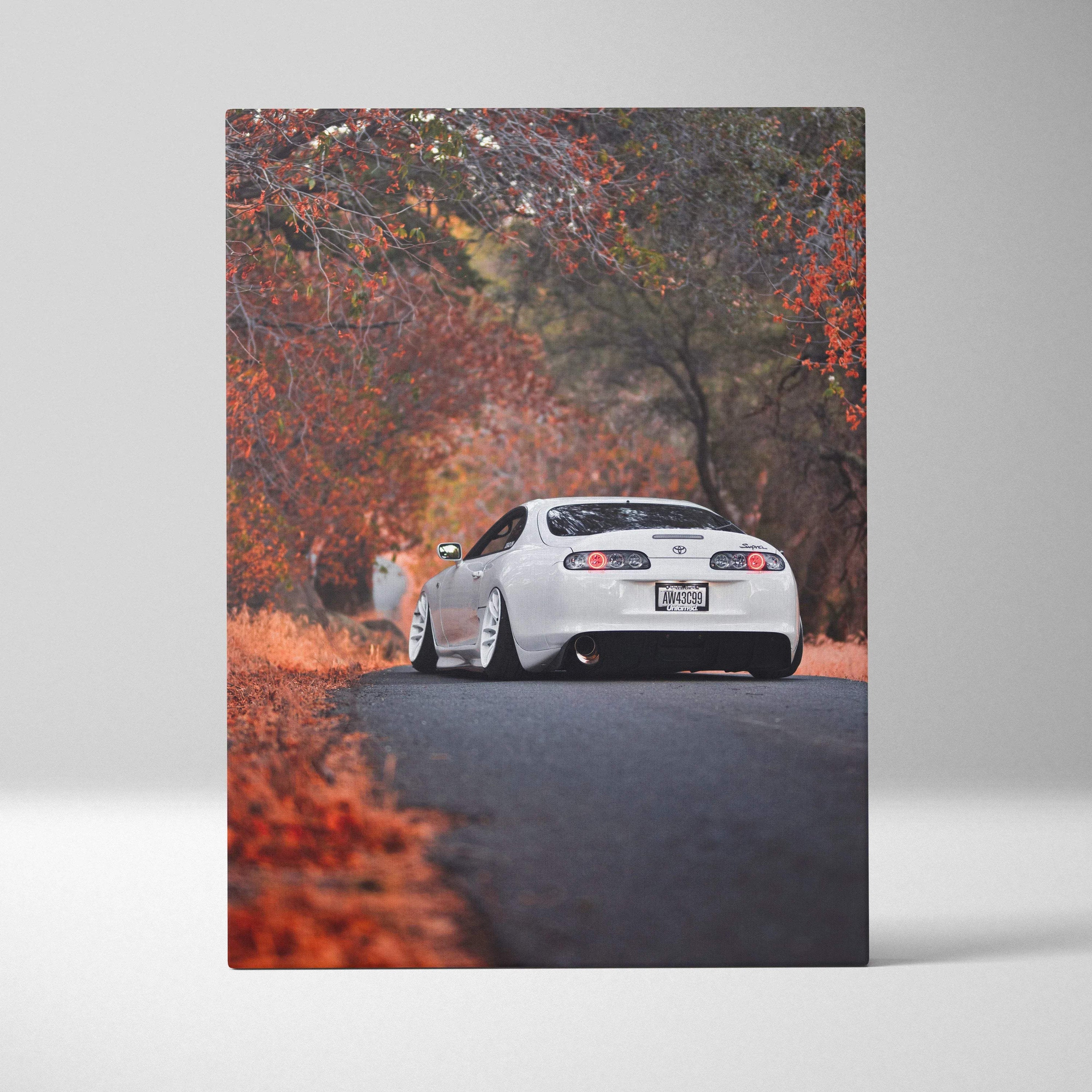 Toyota Supra MK4 on autumn road with vibrant fall foliage canvas wall art.