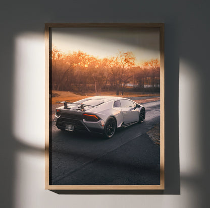 Lamborghini Huracan poster featuring rear view of white sports car at sunset, luxury wall art.