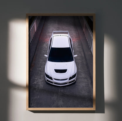 White Mitsubishi Evo 8 poster showing front view in dark urban setting, automotive wall art.