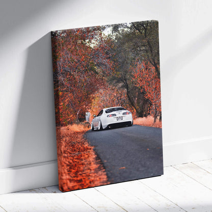 Toyota Supra MK4 driving on road surrounded by autumn trees canvas wall art.