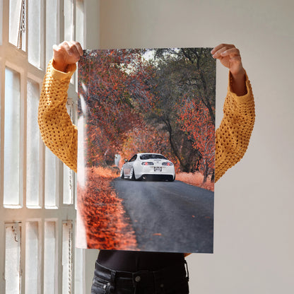 Toyota Supra MK4 racing down autumn road poster wall art with vivid fall foliage.