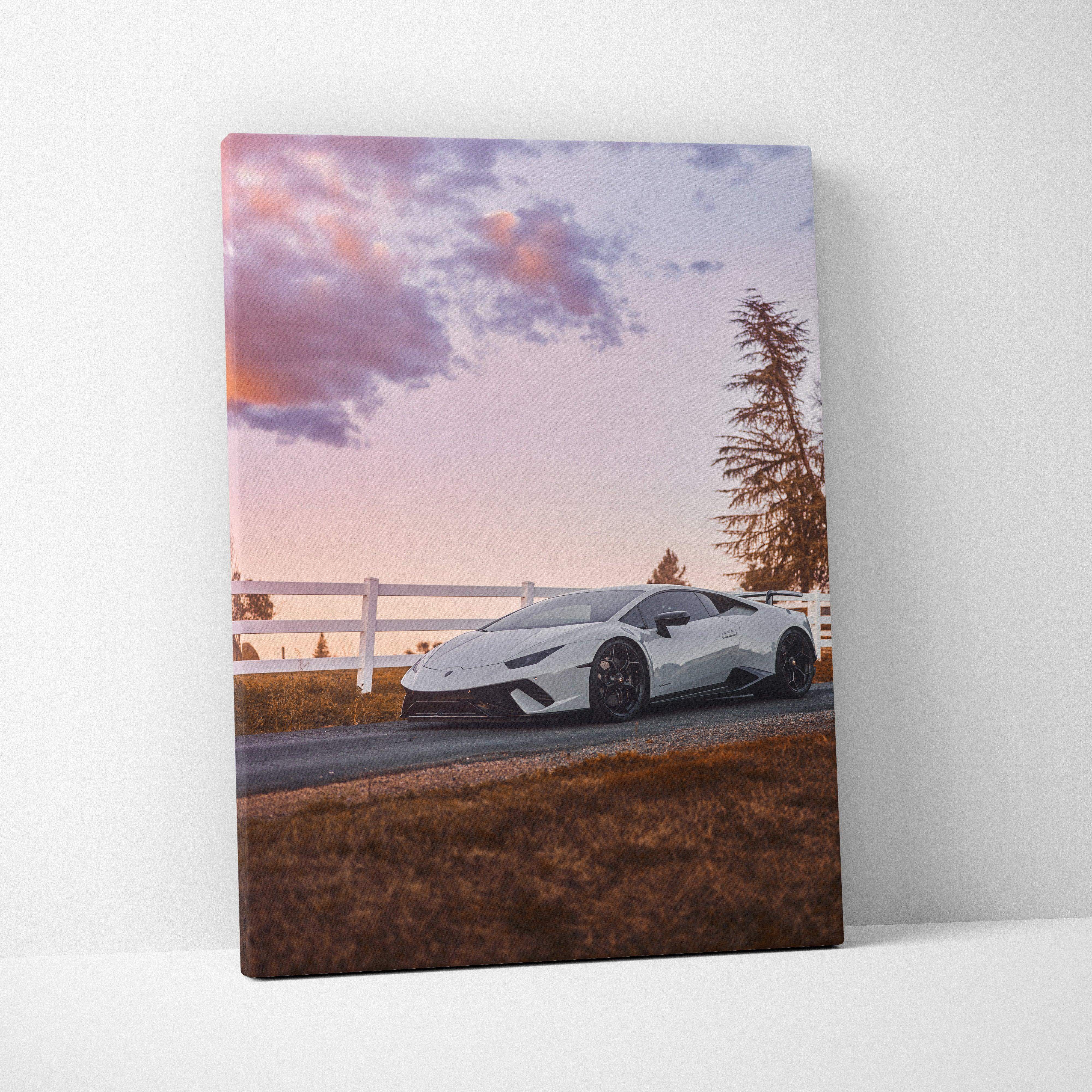 White Lamborghini Huracán canvas wall art featuring a sleek sports car under a soft pink and purple sunset sky